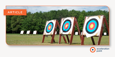A row of archery targets standing in an open field, representing the precision and goal-oriented focus required for Medical Insight Leads to master the skills that drive strategic insights in Medical Affairs.